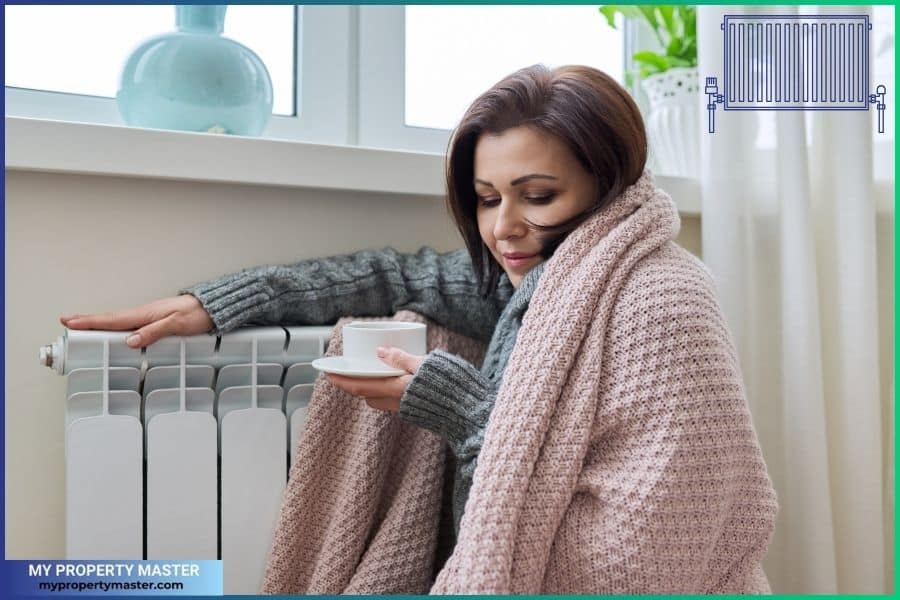 In the winter season, woman warming up near home by heating radiator