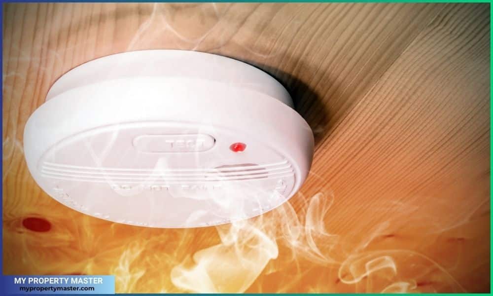 Smoke fire detected by home smoke detector alarm on ceiling
