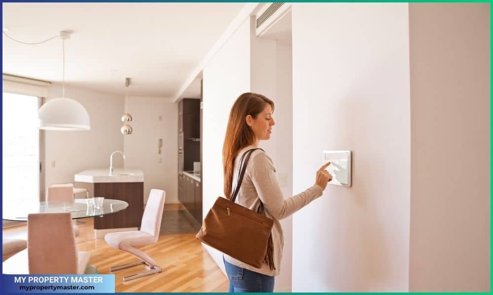 Woman activating smart home security system before leaving