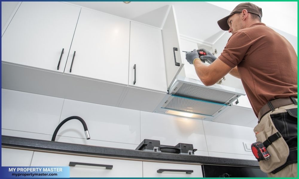 Contractor Worker Assembling of New Apartment Kitchen Cabinets