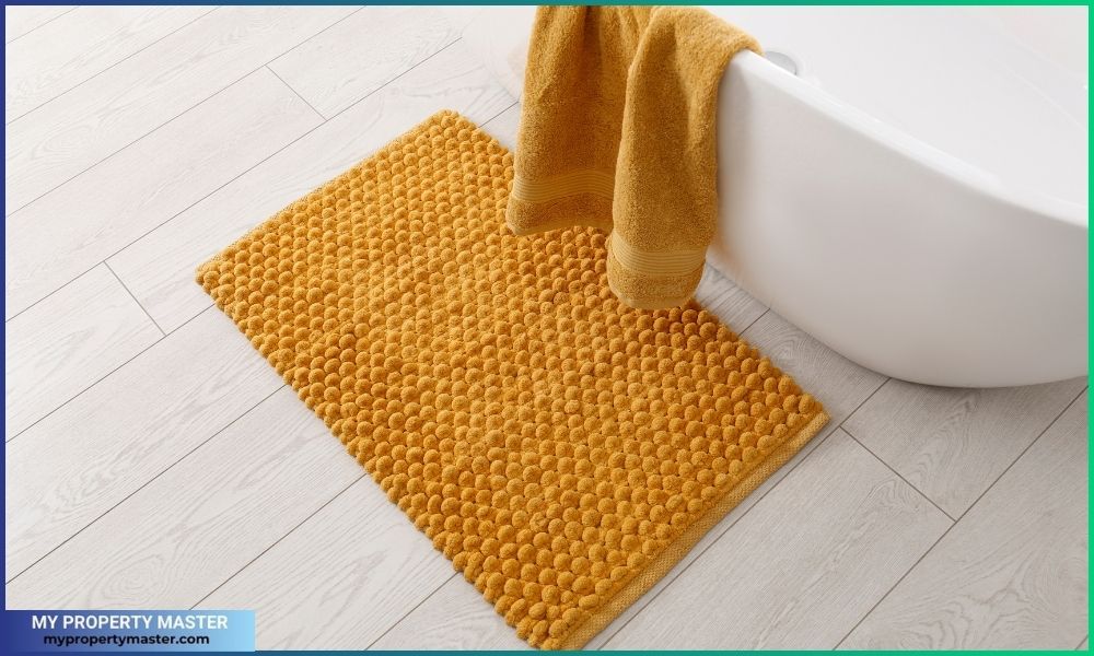 Soft Orange Bath Mat on Floor in Bathroom