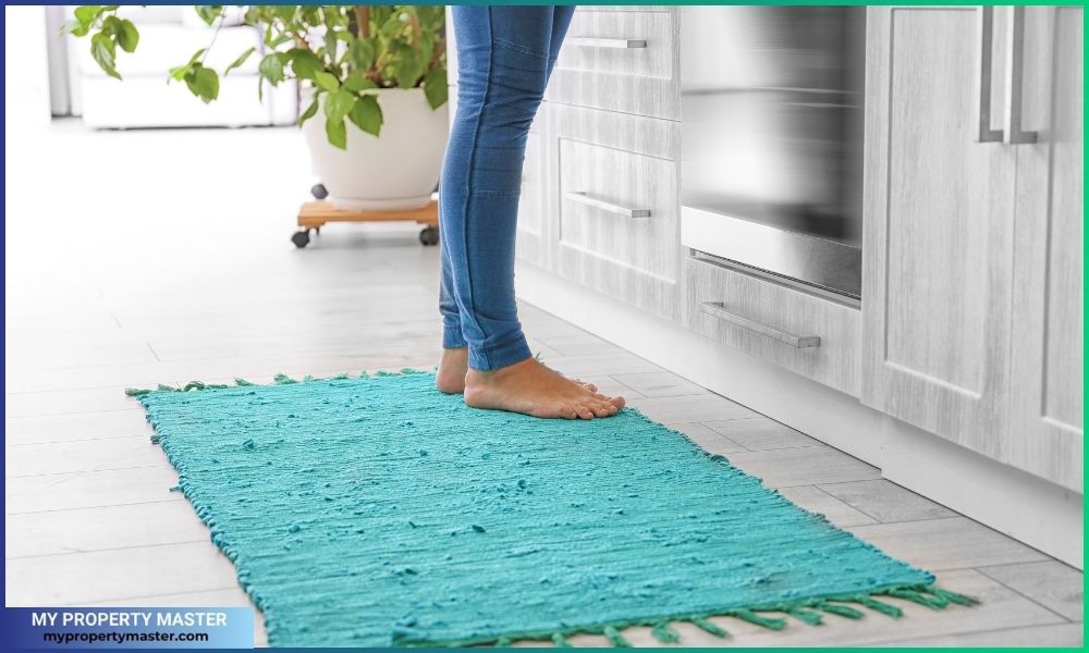 Woman Standing on Rug in Kitchen